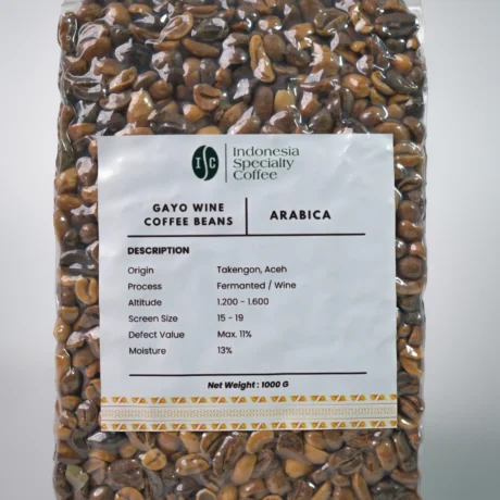 A glass of Gayo Wine Coffee featuring a dark, rich color and a layer of frothy cream, set against a neutral background.